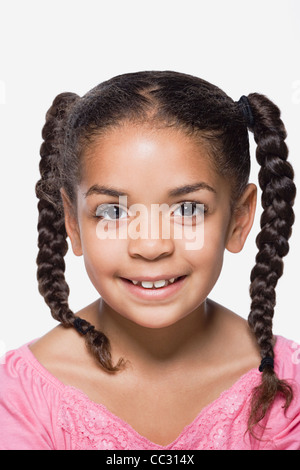 Studio portrait of smiling girl (8-9) avec des tresses, Close up Banque D'Images