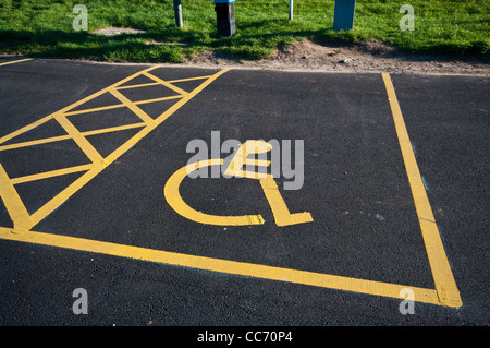 Stationnement pour handicapés inscription peinte sur le tarmac dans un parking parking à UK Banque D'Images
