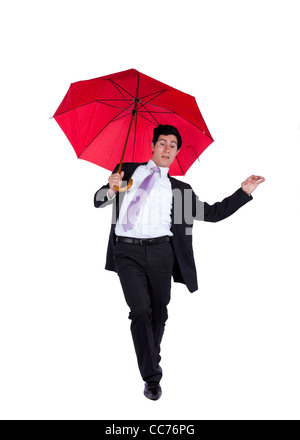 Businessman couvrant lui-même par un parapluie rouge Banque D'Images