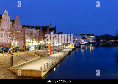 Maisons illuminées sur les rives de la Trave la nuit, ville hanséatique de Lübeck, Schleswig-Holstein, Allemagne, Europe Banque D'Images