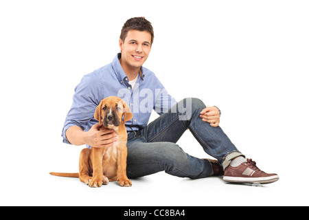 Jeune homme avec un chiot cane corso Banque D'Images