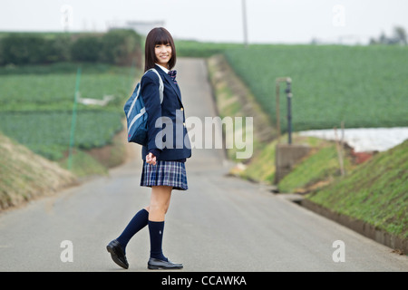 Female High School Student Standing on Rural Road Banque D'Images