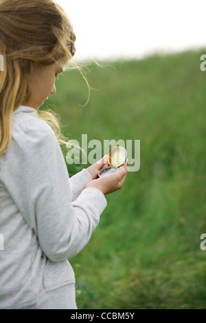 Girl using compass Banque D'Images