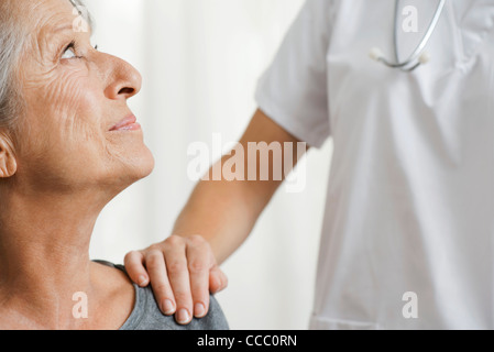 Senior woman with caring doctor, cropped Banque D'Images