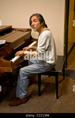 Un sans-abri joue du piano et chante dans un asile de nuit qui a eu lieu dans une église de Glendora, CA. Banque D'Images