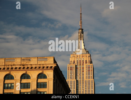 Le haut de l'Empire State Building et un autre bâtiment en fin d'après-midi du soleil. Banque D'Images