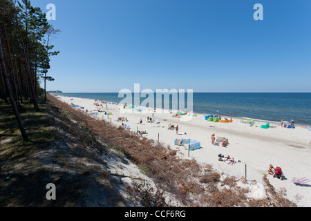 Plage de sable à Pogorzelica. Les gens sont en train de bronzer sur la plage. Début de l'été sur la côte de la mer Baltique. Banque D'Images