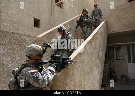 07 avril 2008 - Khalis, province de Diyala, en Iraq - Un soldat des troupes de Cobra, 2e Escadron, 1e régiment de cavalerie dans le cadre de 4e Stryker Brigade Combat Team, 2e Division d'infanterie, regarde l'entrée d'une maison d'assaut irakiens par des soldats de son unité dans la ville de Khalis, province de Diyala en Irak. (Crédit Banque D'Images