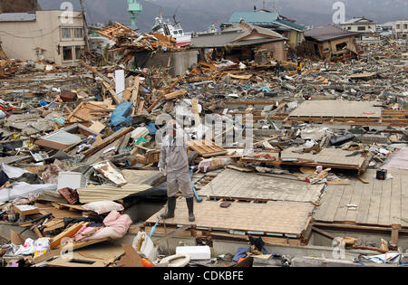 Mar. 15, 2011 - Miyako, le Japon - un homme se dresse sur la maisons effondrées à Miyako. Un tremblement de terre de magnitude 9,0 a frappé le nord du Japon. Des dizaines de milliers de personnes sont toujours portées disparues. (Crédit Image : © Koichi Kamoshida/Jana Press/ZUMAPRESS.com) Banque D'Images