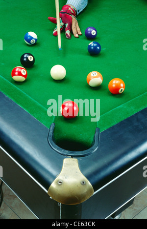 Billards de billard sur la table de billard et homme jouant avec le ballon de CUE Banque D'Images