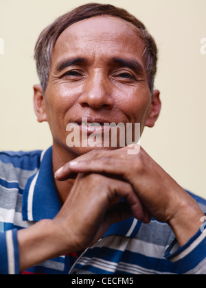 Portrait of happy mature Asian man smiling and looking at camera Banque D'Images