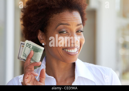 African American Woman holding 50 dollar bill Banque D'Images