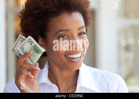 African American Woman holding 50 dollar bill Banque D'Images