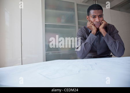 Black businessman reviewing blueprints Banque D'Images