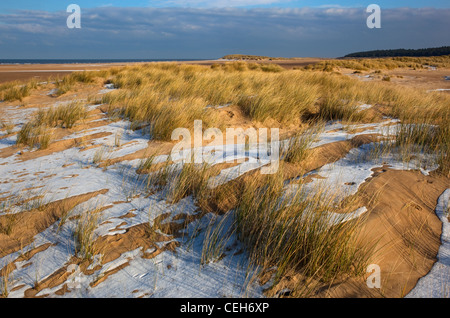 Neige qui recouvre les dunes de sable et la plage de Holkham Norfolk Bay sur la côte en hiver Banque D'Images