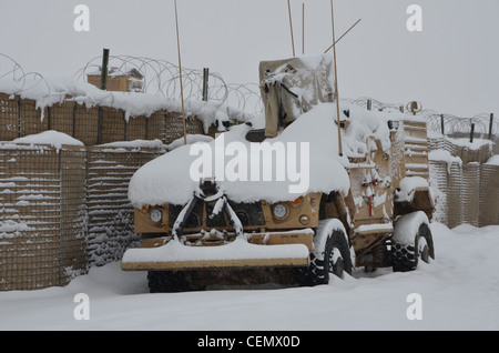 Une mine et les embuscades protégés véhicule tout-terrain est recouvert d'une couverture de neige reçues pendant la nuit sur la base d'opération avancée bullard, Shah Joy, en Afghanistan. Banque D'Images