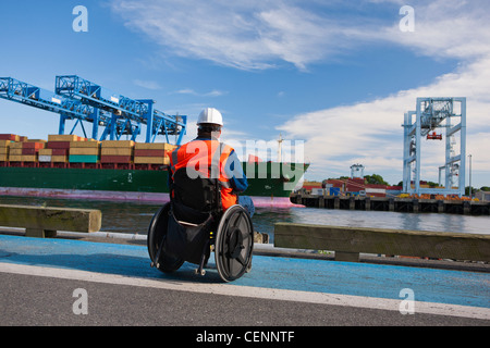 Ingénieur transport fauteuil roulant dans l'inspection des conteneurs au port d'expédition Banque D'Images