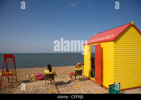 Deux maîtres nageurs assis sur le devoir à l'extérieur de leur cabane sur la plage à Whitstable. Banque D'Images