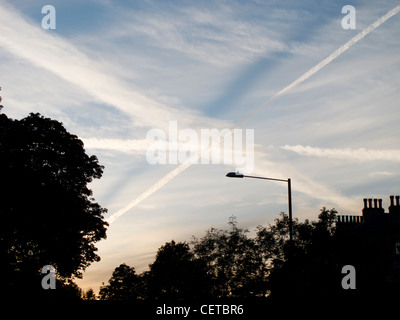 Des traînées de vapeur en forme de X dans le ciel, le soir, Banque D'Images