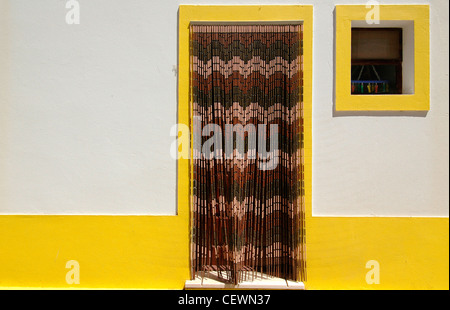 Maison typique avec des bandes d'encadrement jaune à Aljezur Algarve au Portugal du sud de la vieille ville Banque D'Images