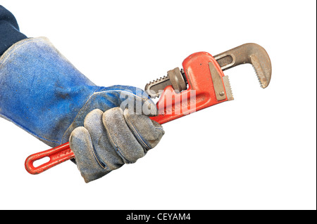 Un homme tenant un vieux rusty, clé à tube de plombier en portant des gants usés atelier. Banque D'Images