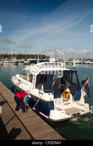 Royaume-uni, Angleterre, île de Wight, Yarmouth marina, femme d'âge moyen plaisir d'amarrage à quai Ardea cruiser Banque D'Images