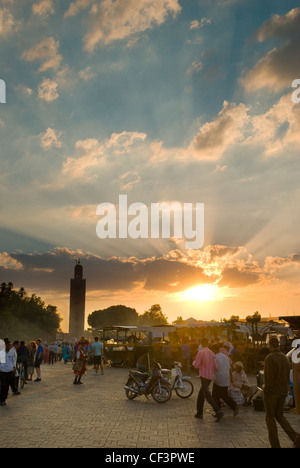 La place Djema El Fna et la mosquée Koutoubia au coucher du soleil. Banque D'Images