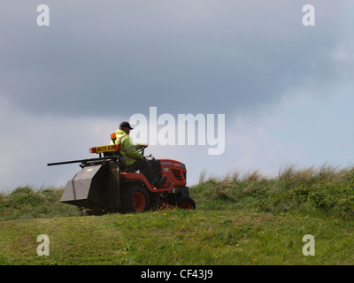 L'herbe de tonte travailleur du Conseil, Cornwall, UK Banque D'Images