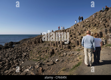 Les touristes profiter de la merveille de la Chaussée des Géants, formé à partir de 40 000 colonnes de basalte d'enclenchement. La Chaussée des Géants est un Wo Banque D'Images