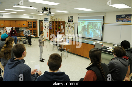 La vidéoconférence en classe d'étudiants américains avec un chercheur à une station au Panama- boy avec micro poser question Banque D'Images