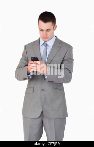 Close up of businessman texting Banque D'Images