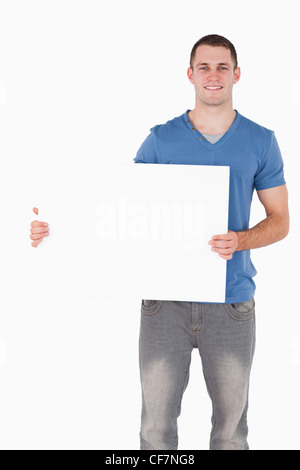 Portrait of a young man holding a blank panel Banque D'Images