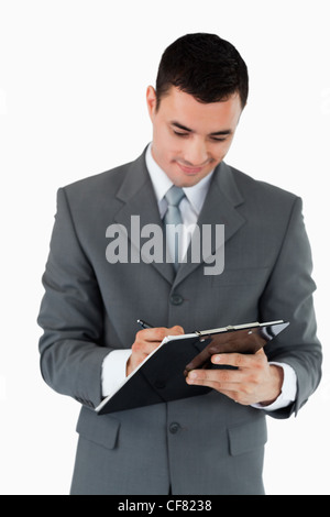 Businessman taking notes sur le presse-papiers Banque D'Images
