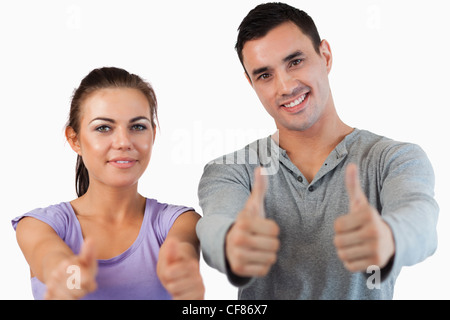 Jeune couple giving Thumbs up Banque D'Images