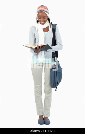 Smiling young student reading a book Banque D'Images