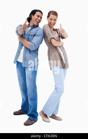 Smiling young couple giving Thumbs up Banque D'Images