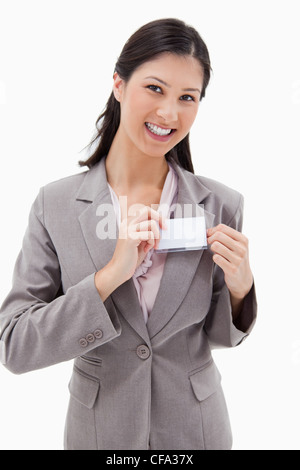 Smiling businesswoman putting on-nom Banque D'Images