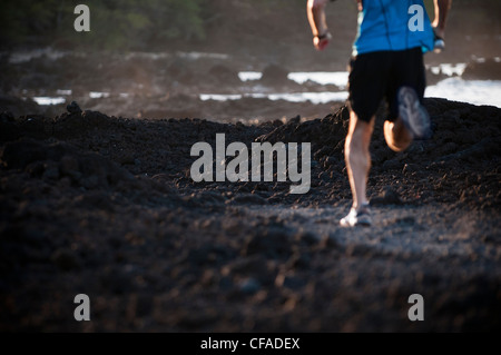 Man running on Rocky beach Banque D'Images