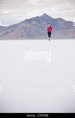 Woman running in desert landscape Banque D'Images