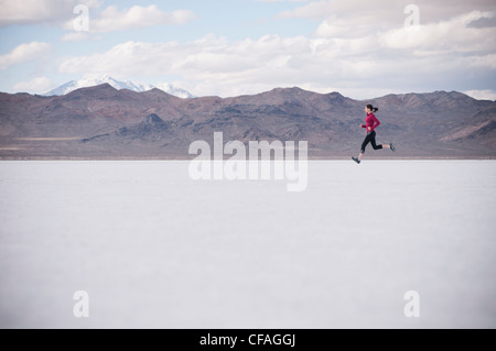 Woman running in desert landscape Banque D'Images