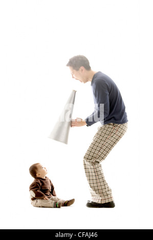 Homme asiatique de 43 ans avec un porte-voix, criant à un âge de 10 mois bébé garçon eurasien, Montréal, Québec, Canada. Banque D'Images