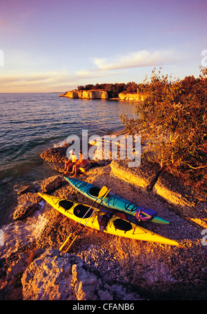 Couple le long de falaises calcaires avec des kayaks, Steep Rock Beach Park, le lac Manitoba, Manitoba, Canada Banque D'Images