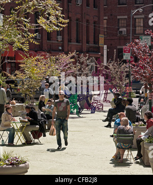 Un homme marche à travers un plaza à Brooklyn dans la zone d'entrepôt appelé Dumbo (down under Manhattan Bridge overpass). Banque D'Images