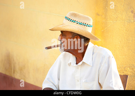 Les homme portant un chapeau de paille et fumer un cigare, Trinidad, Cuba, Antilles, Amérique Centrale Banque D'Images