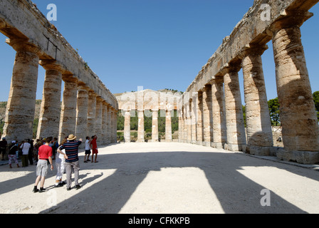 La Sicile. L'Italie. Avis de touristes en regardant vers l'arrière de l'intérieur de l'ancien grec classique temple dorique de Ségeste Banque D'Images