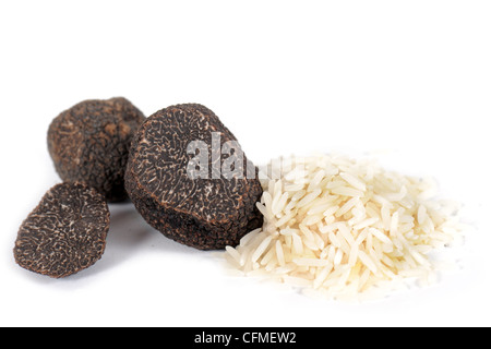 Truffes noires (tuber melanosporum) avec du riz devant un fond blanc Banque D'Images