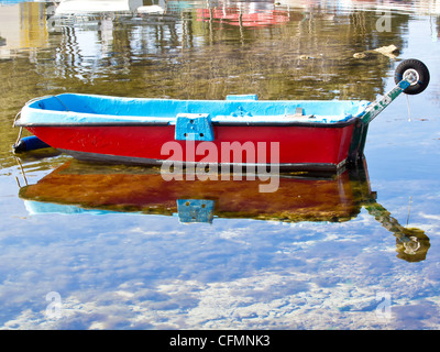 Drôle de petit bateau rouge avec des pneus de voiture Banque D'Images