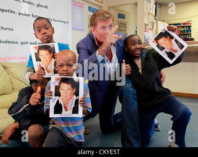 JOHANNESBURG, AFRIQUE DU SUD : David Hasselhoff parle aux jeunes patients atteints du cancer à l'hôpital Chris Hani Baragwanath le 31 août 2012 à Johannesburg, Afrique du Sud. Hasselhoff a visité l'hôpital alors qu'en Afrique du Sud d'effectuer à l'Avastar night club le 1 septembre 2012. (Photo par Gallo Images / Sunday Times / Simphiwe Nkwali) Banque D'Images