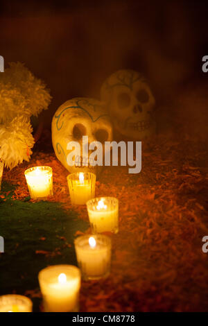 Esvestidas Alborotadoras "Y' Ofrenda - Autel offrant commémoration de femmes avec un hommage particulier à Sor Juana María et Félix - Détail de calavera (crâne) et des bougies sur l'autel dans le brouillard d'encens Banque D'Images