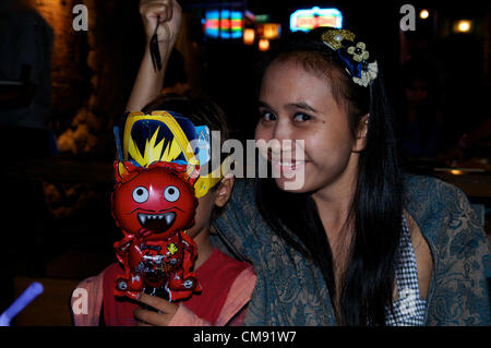 Bangkok, Thaïlande, le 31/10/12 mère Thai sticks fourchette dans la tête de son fils pour l'Halloween, Tawandang German Brewery. © Kraig Lieb Banque D'Images